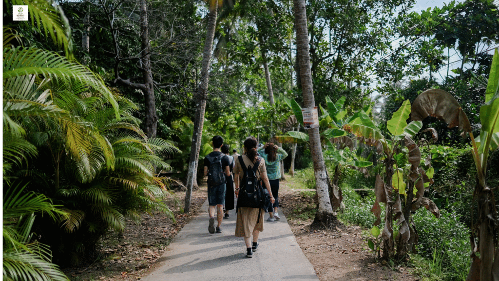 Group of eco-conscious travelers walking along a lush forest trail, surrounded by greenery