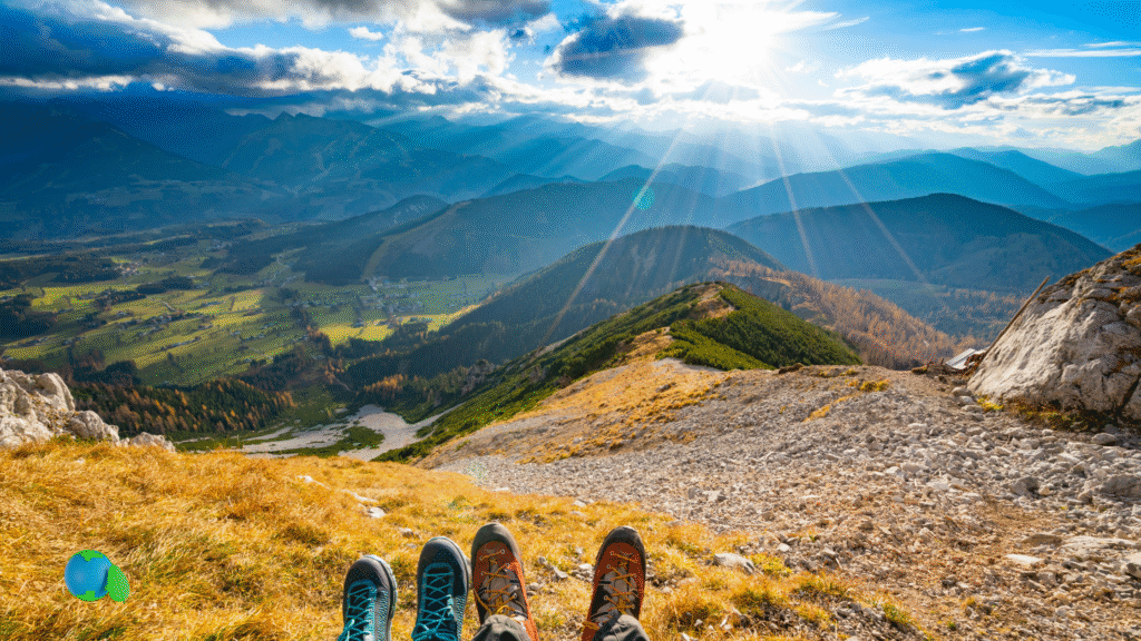 Traveler practicing low-impact travel habits while overlooking a scenic mountain vista