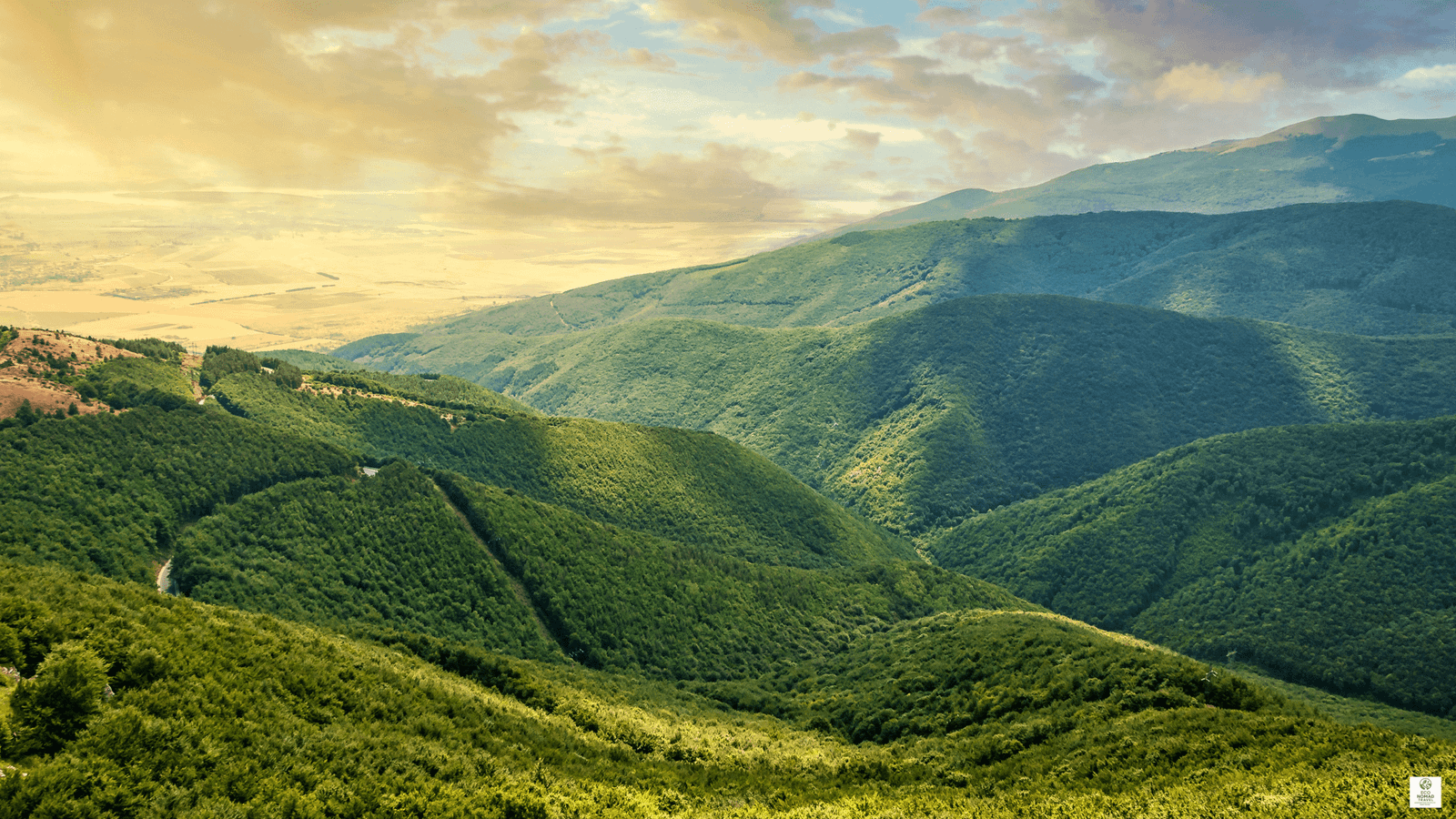Balkan Mountains panorama with rugged peaks and forested valleys on a slow-travel route