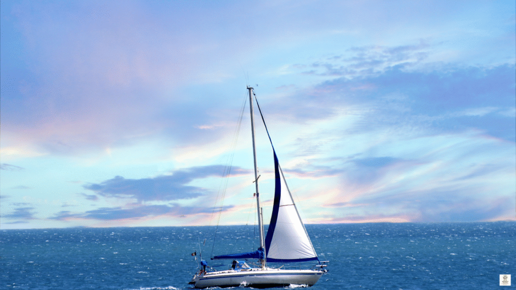 White sailing yacht cutting through clear Adriatic water off the coast of Croatia on a sunny day