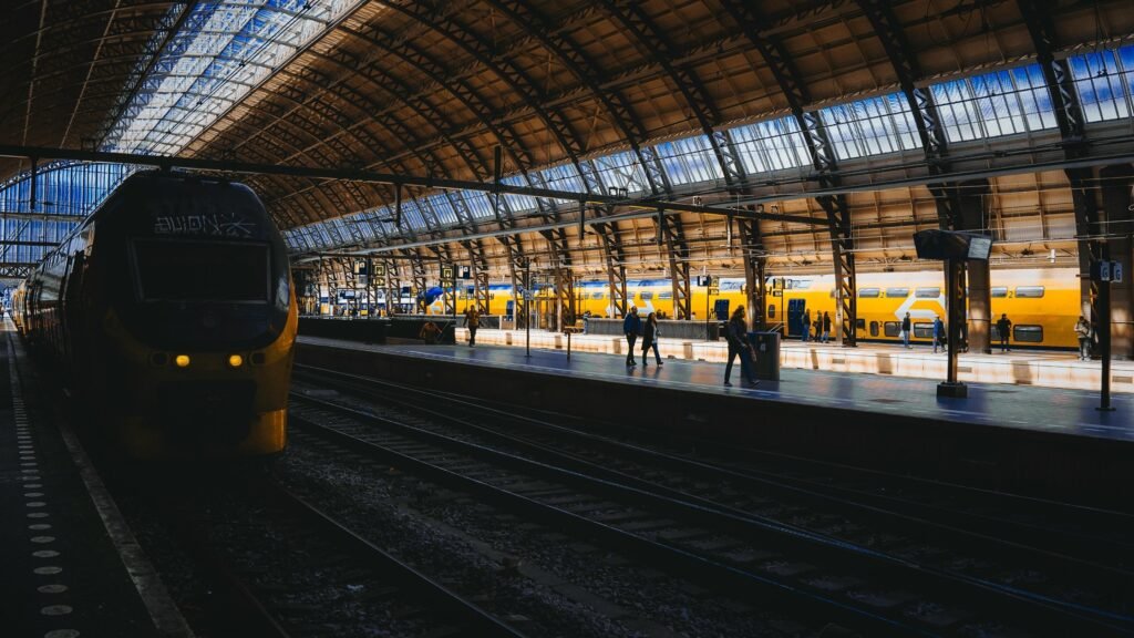 How to travel cheap in Europe by train with yellow trains at Amsterdam Central Station